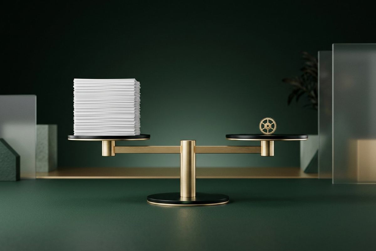A modern brushed-gold balance weighing a tall stack of paper against a single small gear, in a clean green studio with frosted glass panels
